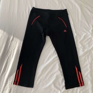 Black adidas Capri leggings with neon detail.